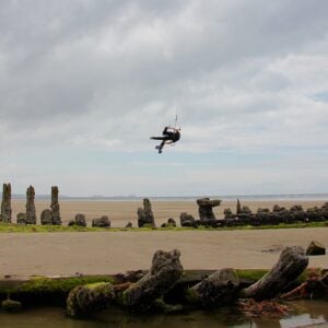 FLYING-OVER-ROCKS-BEACH-KITEBOARD-SLIDERS-IMAGE